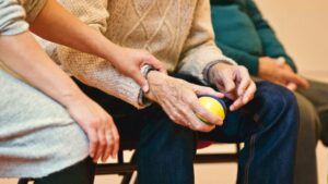 Elderly Man Exercising His Hand with a Rubber Ball - What is the Process of Aging