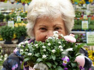 Senior Woman Hiding Her Face Behind Some Flowers