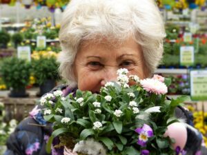 Woman hiding face behind flowers - Incontinence in Seniors