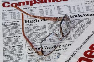 Reading glasses placed on top of a newspaper