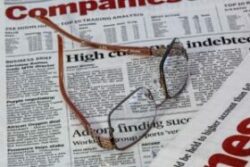 Reading glasses placed on top of a newspaper - Changes in the Body With Age