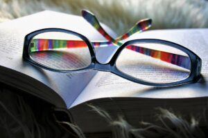 Reading glasses placed on an open book - Eye Health in Seniors