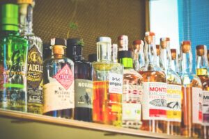 Many bottles of alcoholic drinks on a shelf - Senior Mobility Aids