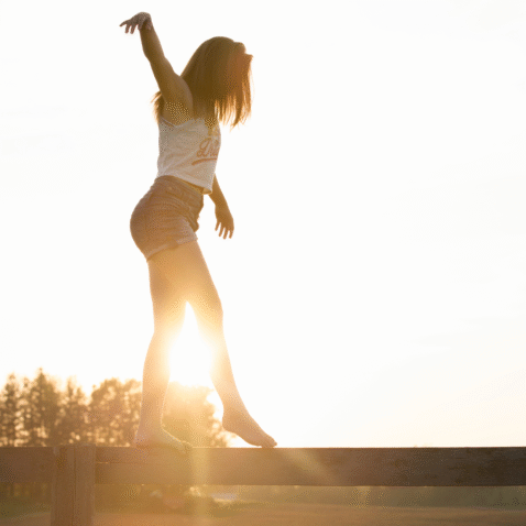 A Woman Trying to Maintain Her Balance While Walking Along a Narrow Strip -What are the Symptoms of a Stroke