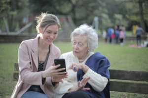Elderly woman with daughter looking at a cell phone - Dementia Risk Factors