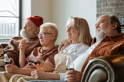 Four seniors sitting down on a sofa - Dementia Risk Factors