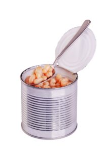An opened tin of canned white beans with a spoon in it