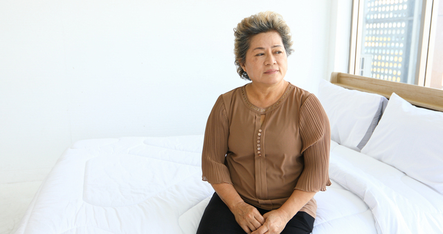 An-elderly-woman-sitting-alone-on-the-bed - Senior Safety in the Bedroom