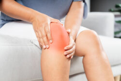 Woman with inflammation causing knee pain