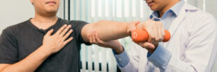 What are Natural Remedies? - 10 Common Groups 4 Physical-therapy-by-physiotherapist-on-patients-arm-with-hand-holding-a-dumbbell - What are Natural Remedies