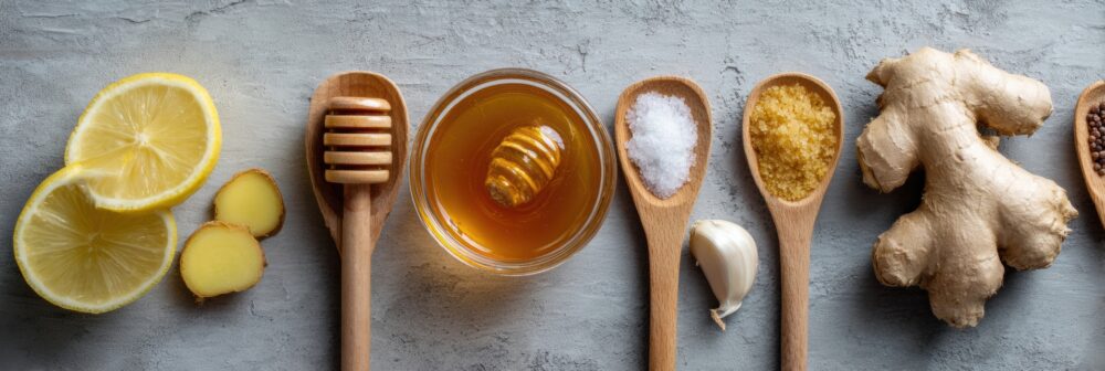 Home Cold Remedies Featuring Honey, Ginger, Garlic, and Lemon Arranged in a Flat Lay on a Minimal Surface - Natural Home Cures