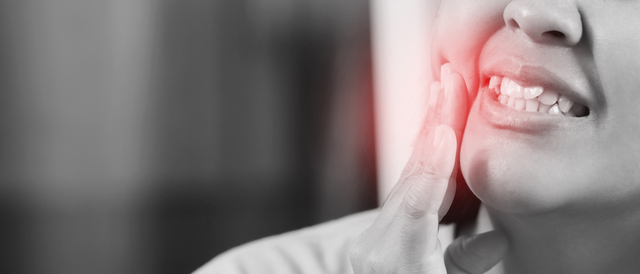 woman with toothache - Best 6 Home Toothache Remedies