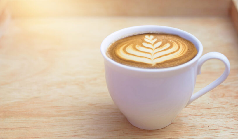 hot latte coffee cup in wooden background - 17 Effects of Caffeine on the Body