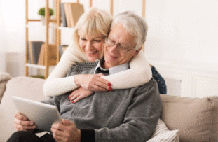 Senior man and woman read from a tablet - Incontinence in Seniors