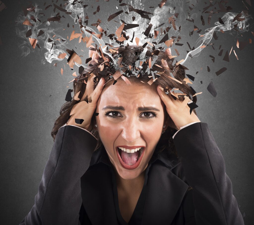 Stressed head of a screaming business woman in smoke - How Does Stress Affect Aging