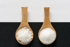 two wooden spoons with sugar and salt - 8 Facts About Salt vs Sugar