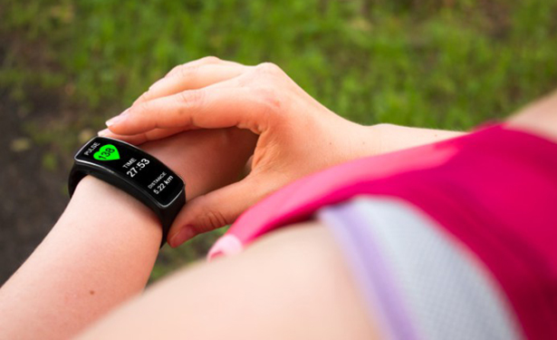 Sporty woman using smart watch.-Fitness Trackers for Seniors