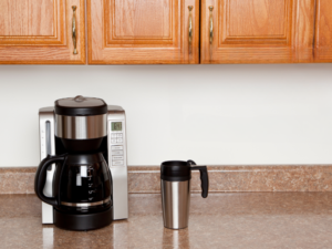 coffee maker brewing coffee on a kitchen counter with an insulated cup beside it- coffee maker brewing coffee on a kitchen counter with an insulated cup beside it- coffee maker brewing coffee on a kitchen counter with an insulated cup beside it- 7 Best Coffee Makers for Home Use