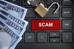 Scam text on red laptop tab with locker and bank notes background - Revealing 5 Common Financial Scams Targeting Seniors