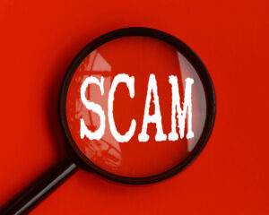 Scam text on red cover with magnifying glass - Top Senior Scams