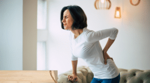 Womain experiencing lower back pain - 5 Natural Muscle Relaxers for Back Pain