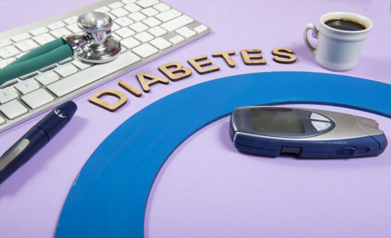 Keyboard and stethoscope on lilac background, with the word Diabetes-Diabetes and the Kidneys