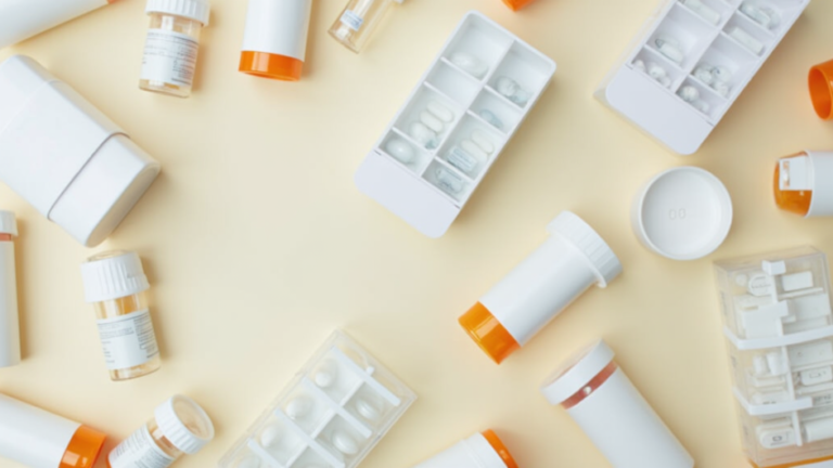 Pills in containers and sachets on a table - Medication Management for Older Adults