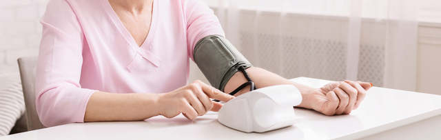 Senior woman measuring her blood pressure at home.-Naturally Lower Blood Pressure - 7 No Pill Ways